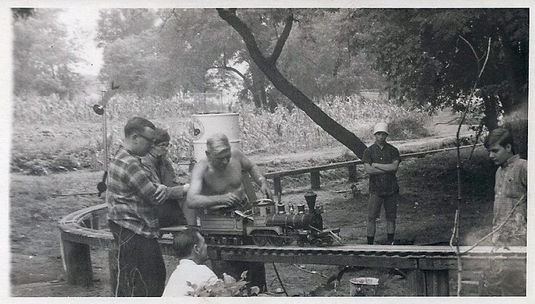 George Gaunt working on a live-steam locomotive in the backyard of the Gaunt House