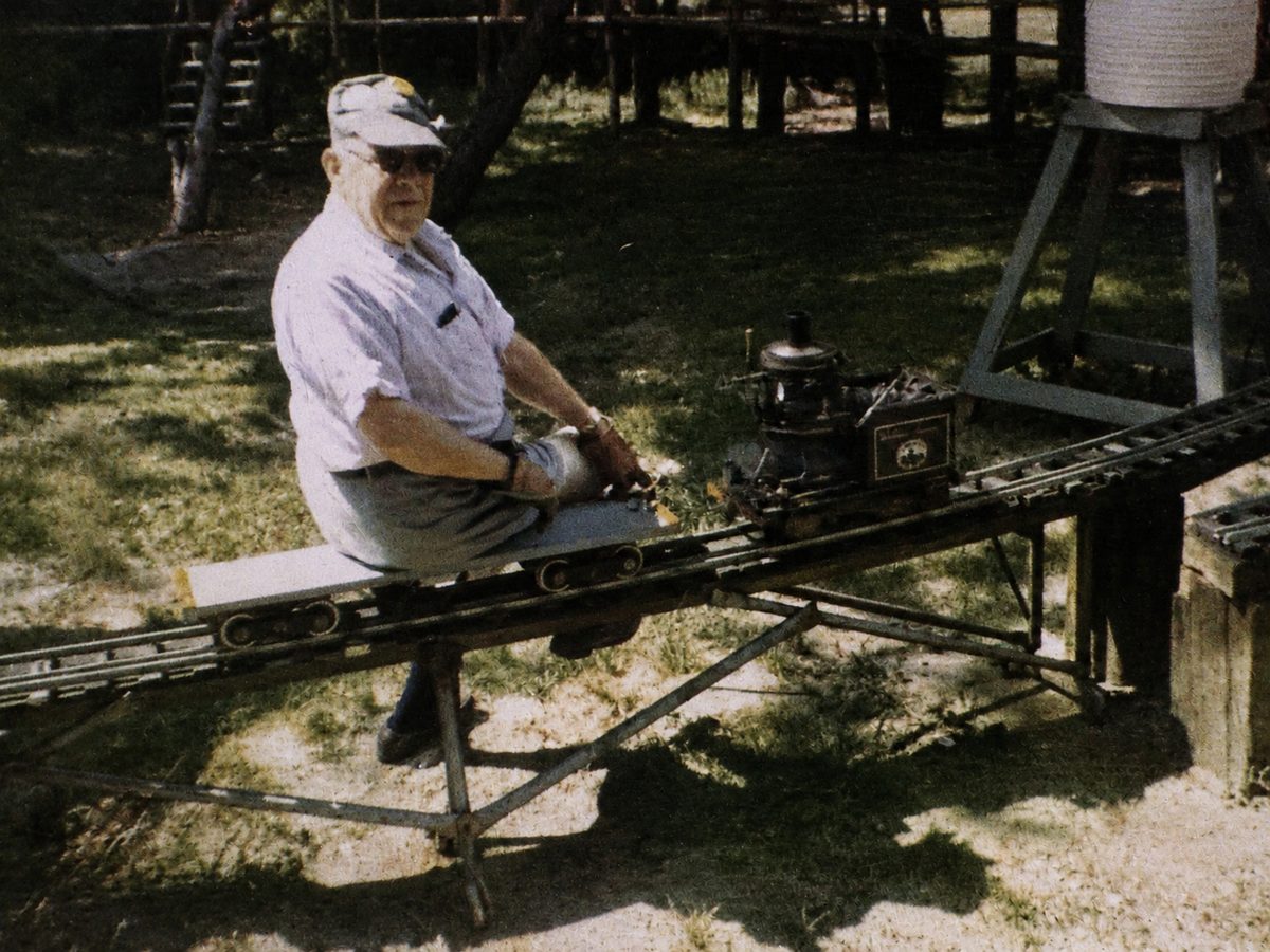 George Gaunt riding the live-steam railway in the backyard of the Gaunt House