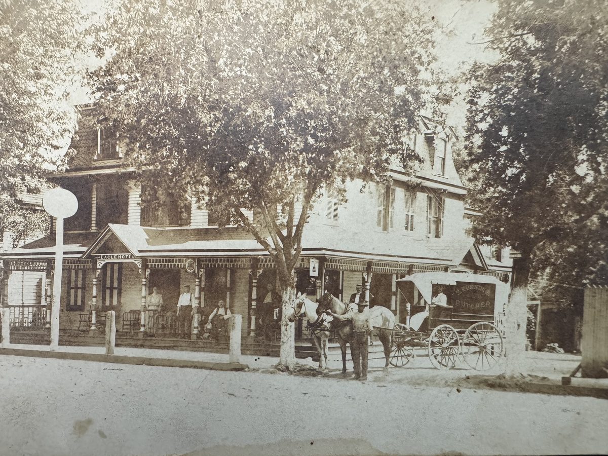 Period photograph of the Eagle Hotel with horses and a butcher's wagon out front